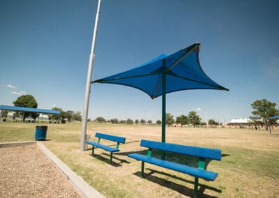Blue waterproof umbrella shade above benches
